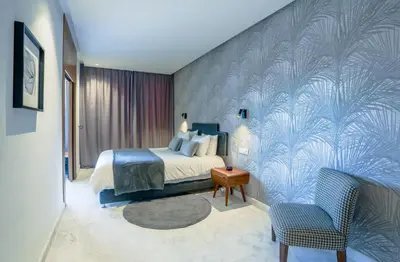 a bedroom with a bed and a blue wall at Lavish Flat in new city #fastwifi#Parking in Casablanca