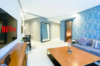 a living room with a couch and a table at Royal Massira flat in shopping center#wifi#parking in Casablanca
