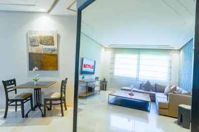 a living room with a couch and a table at Royal Massira flat in shopping center#wifi#parking in Casablanca
