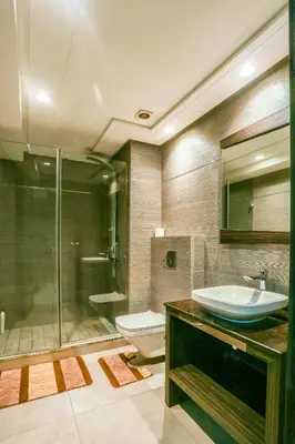 a bathroom with a sink and a toilet and a shower at Royal Massira flat in shopping center#wifi#parking in Casablanca