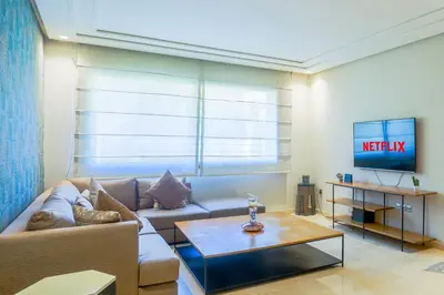a living room with a couch and a tv at Royal Massira flat in shopping center#wifi#parking in Casablanca