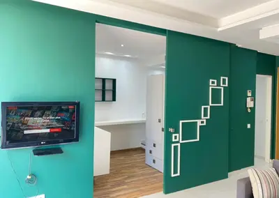 a room with a green door with a video game on it at GREEN HOUSE OVERLOOKING INTERNATIONAL SCHOOL in Casablanca