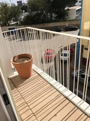 a pot on a balcony with a view of a parking lot at GREEN HOUSE OVERLOOKING INTERNATIONAL SCHOOL in Casablanca