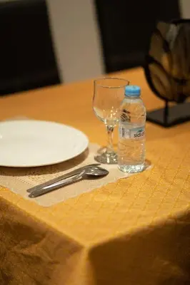 a bottle of water and a glass on a table at Racine Two bedroom flat near twin center in Casablanca