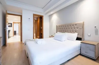 a white bedroom with a large white bed with white pillows at Racine Two bedroom flat near twin center in Casablanca