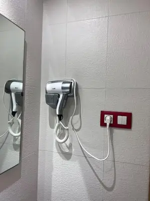 a phone on a wall next to a mirror at Racine bd anfa Appart style tokyo near twin center in Casablanca