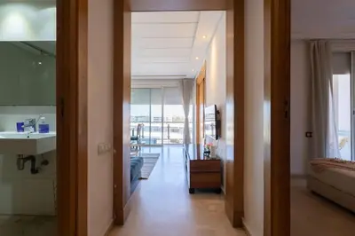 a hallway leading to a living room with a view of a room at Racine bd anfa Appart style tokyo near twin center in Casablanca