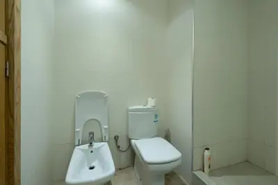 a white bathroom with a toilet and a sink at Racine bd anfa Appart style tokyo near twin center in Casablanca
