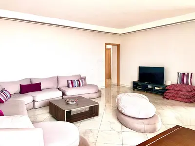 a living room with a couch and a tv at Anfa 118 - Best view in town - 3 bedrooms - 2 Bathrooms in Casablanca