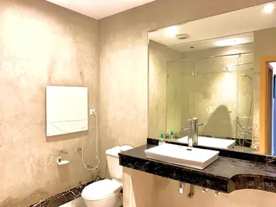 a bathroom with a sink and a toilet and a mirror at Anfa 118 - Best view in town - 3 bedrooms - 2 Bathrooms in Casablanca