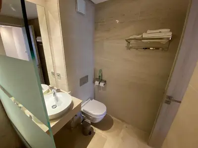 a bathroom with a sink and a toilet and a mirror at Très beau studio à Ain Diab in Casablanca
