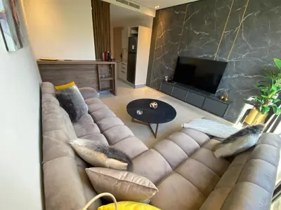 a living room with a couch and a television at Très beau studio à Ain Diab in Casablanca