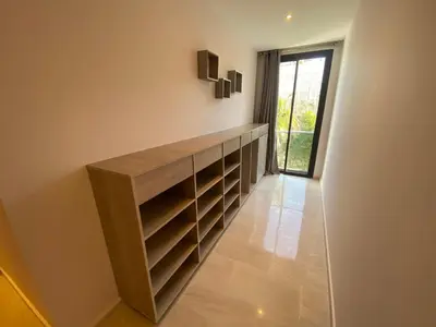 a dressing room with shelves and a window at Très beau studio à Ain Diab in Casablanca