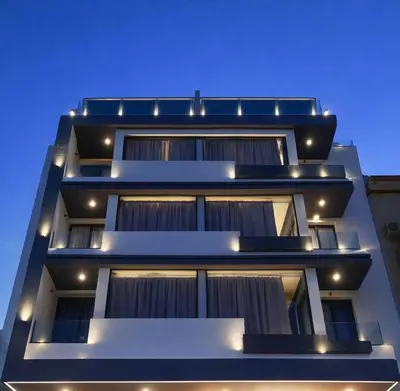 a tall building with lights on it at night at Atlas-Résidence by Rent-Inn in Rabat