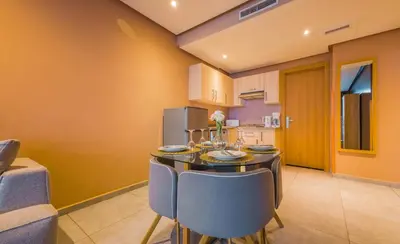 a kitchen with a dining room table and chairs at Atlas-Résidence by Rent-Inn in Rabat