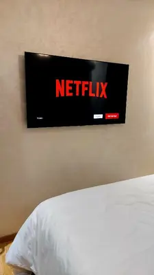 a sign hanging on a wall above a bed at luxury apartment opposite HASSAN 2 MOSQU and FAIR international casablanca and SEA , near downtwn , INTERDIT COUPLES ARAABIC NON MARIÈ, FORBIDDEN UNMARRIED ARAABIC COUPLES , 2 room, 2 living rooms and 2 bathrooms basement car park FREE , apartment with in Casablanca