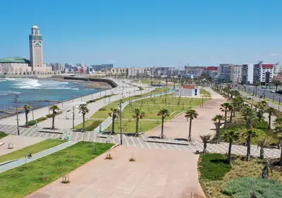 a view of a city with a clock tower and the ocean at luxury apartment opposite HASSAN 2 MOSQU and FAIR international casablanca and SEA , near downtwn , INTERDIT COUPLES ARAABIC NON MARIÈ, FORBIDDEN UNMARRIED ARAABIC COUPLES , 2 room, 2 living rooms and 2 bathrooms basement car park FREE , apartment with in Casablanca