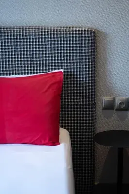 a red pillow sitting on top of a bed at #56 Maarif Racine urban Massira near twin center in Casablanca