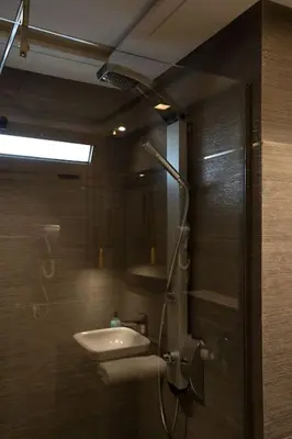 a bathroom with a shower with a sink and a mirror at #56 Maarif Racine urban Massira near twin center in Casablanca