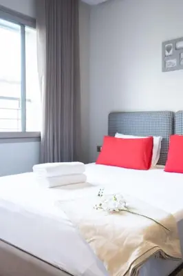 a bedroom with two beds with red and white pillows at #56 Maarif Racine urban Massira near twin center in Casablanca