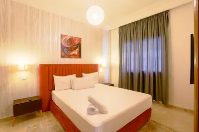 a bedroom with a bed with a stuffed animal on it at Racine appartement near twin center #heart of town in Casablanca