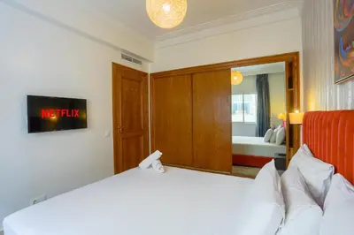 a hotel room with a bed and a mirror at Racine appartement near twin center #heart of town in Casablanca