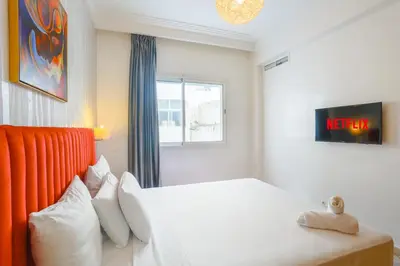 a bedroom with a white bed and a window at Racine appartement near twin center #heart of town in Casablanca
