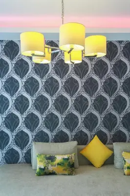 a living room with yellow pillows and a black and white wall at Racine appartement near twin center #heart of town in Casablanca