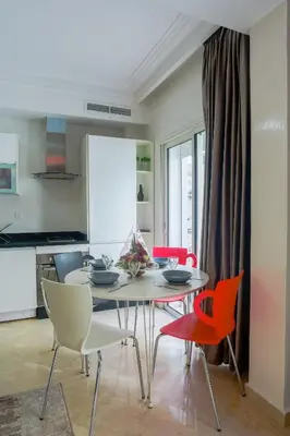 a dining room with a table and chairs at Racine appartement near twin center #heart of town in Casablanca