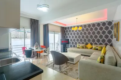 a living room with a couch and a table at Racine appartement near twin center #heart of town in Casablanca