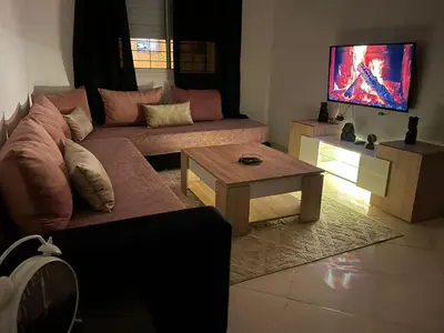 a living room with a couch and a coffee table at Lovely 1-Bed Apartment in Skhirat in Skhirat