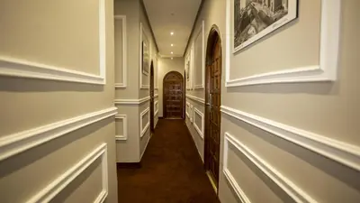 a hallway of a home with white walls and a door at Hotel de paris in Casablanca
