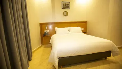 a bedroom with a large bed with white sheets at Hotel de paris in Casablanca