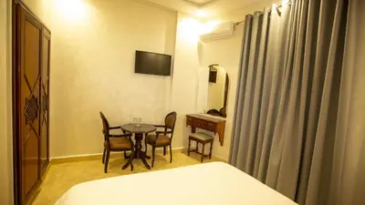 a room with a table and chairs and a bed at Hotel de paris in Casablanca