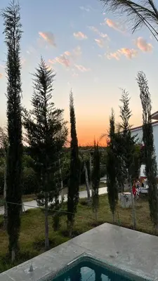 a view of a yard with a pool and trees at Dar Ghita en campagne in O Ben Slimane