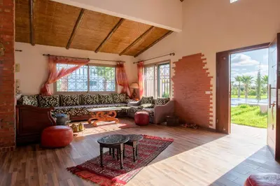 a living room with a couch and a table at Dar Ghita en campagne in O Ben Slimane