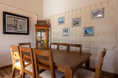 a dining room with a wooden table and chairs at Dar Ghita en campagne in O Ben Slimane