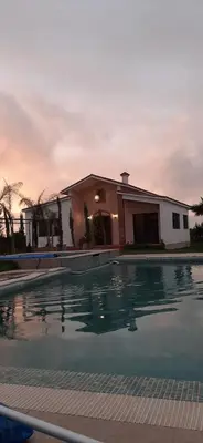 a house with a swimming pool in front of a house at Dar Ghita en campagne in O Ben Slimane