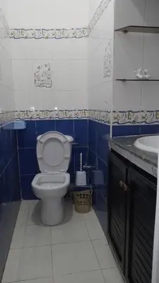 a blue and white bathroom with a toilet and a sink at Paradise house in Casablanca