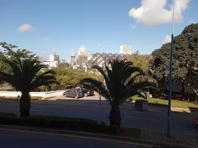 a street with palm trees and a city in the background at Paradise house in Casablanca