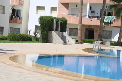 a swimming pool in front of a building at MOHAMMEDIA 304 in Mohammedia