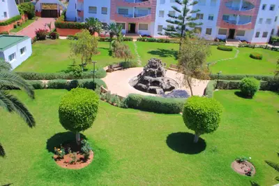 an aerial view of a park with trees and a fountain at MOHAMMEDIA 304 in Mohammedia