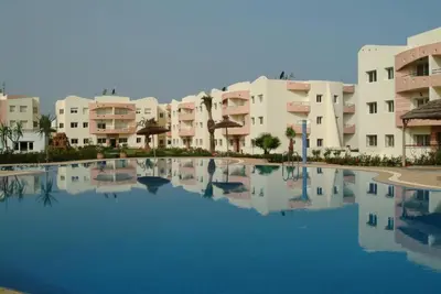 a large swimming pool in front of some apartment buildings at MOHAMMEDIA 304 in Mohammedia
