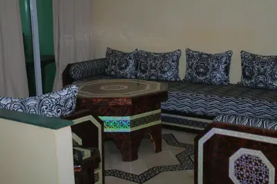 a living room with a couch and a table at MOHAMMEDIA Residence KAWTAR in Mohammedia