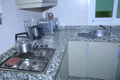 a kitchen with a stove and a counter top at MOHAMMEDIA Residence KAWTAR in Mohammedia