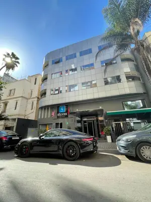 a black car parked in front of a building at Silver Suites Hotel & Spa Casablanca in Casablanca