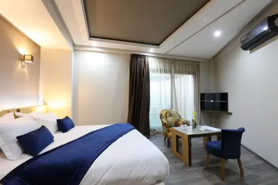 a hotel room with a bed and a table at Silver Suites Hotel & Spa Casablanca in Casablanca