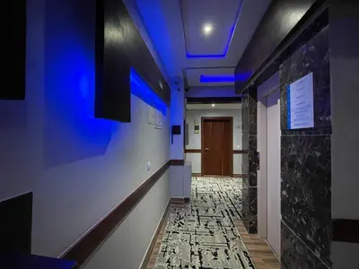 a hallway with a tile floor and a blue ceiling at Silver Suites Hotel & Spa Casablanca in Casablanca