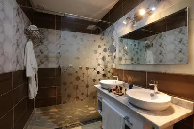 a bathroom with two sinks and a mirror at Silver Suites Hotel & Spa Casablanca in Casablanca