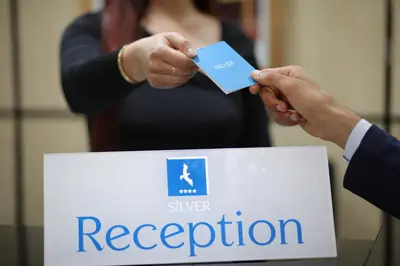 a person in a suit holding a blue credit card at Silver Suites Hotel & Spa Casablanca in Casablanca